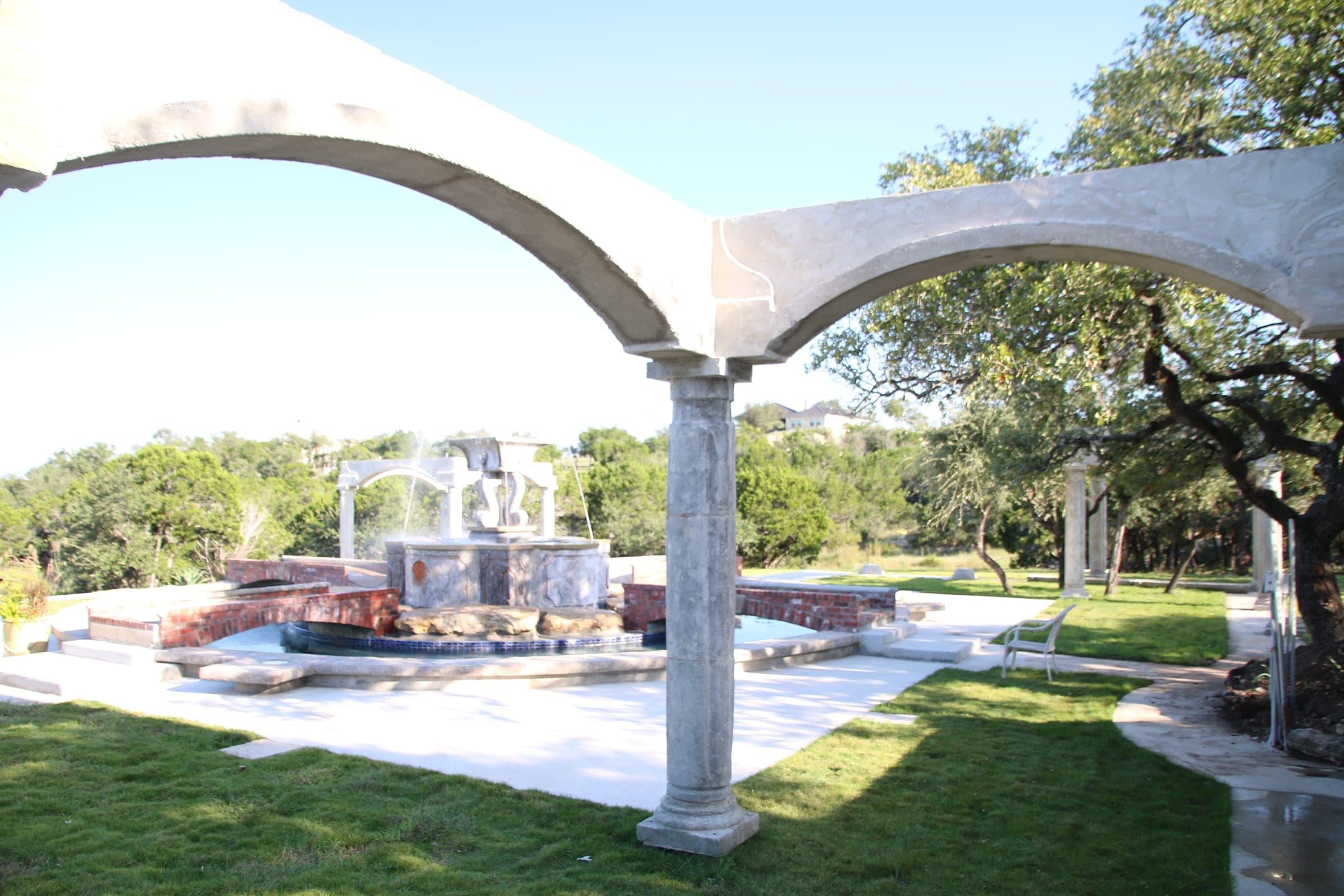 Stone arch and pergola beside the fountain
