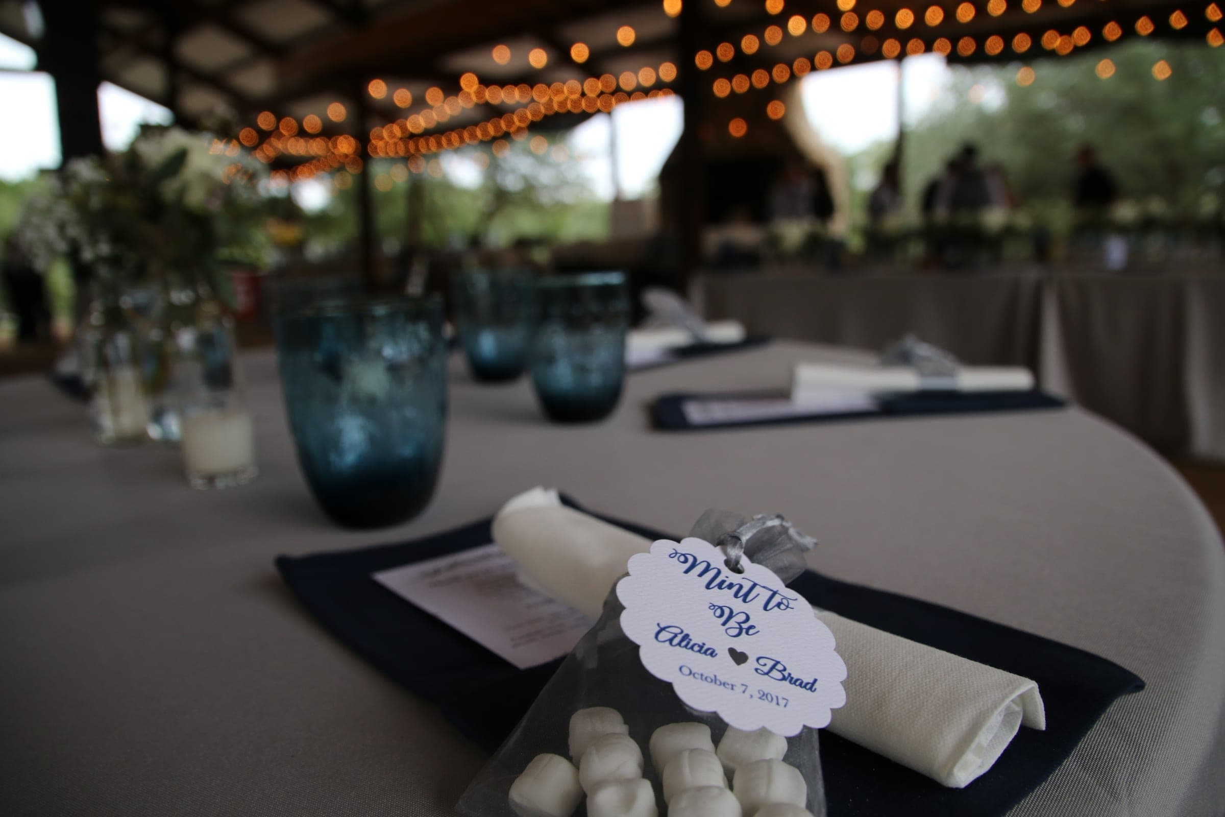 Table setting detail with blue glassware and candlelight
