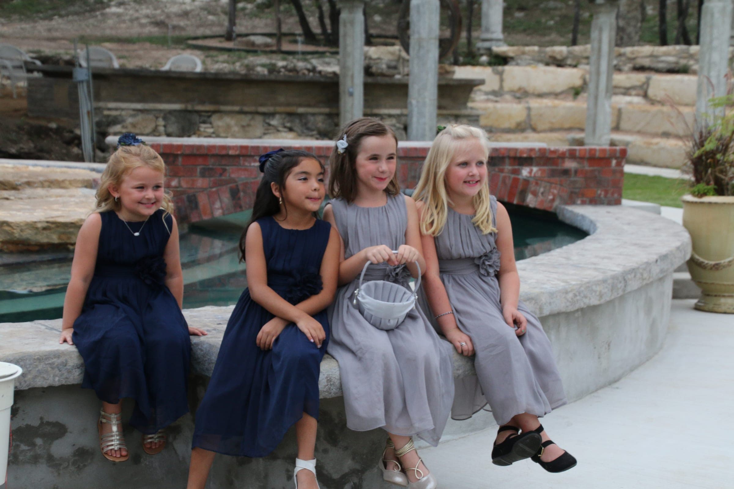 Flower girls seated at the fountain's edge