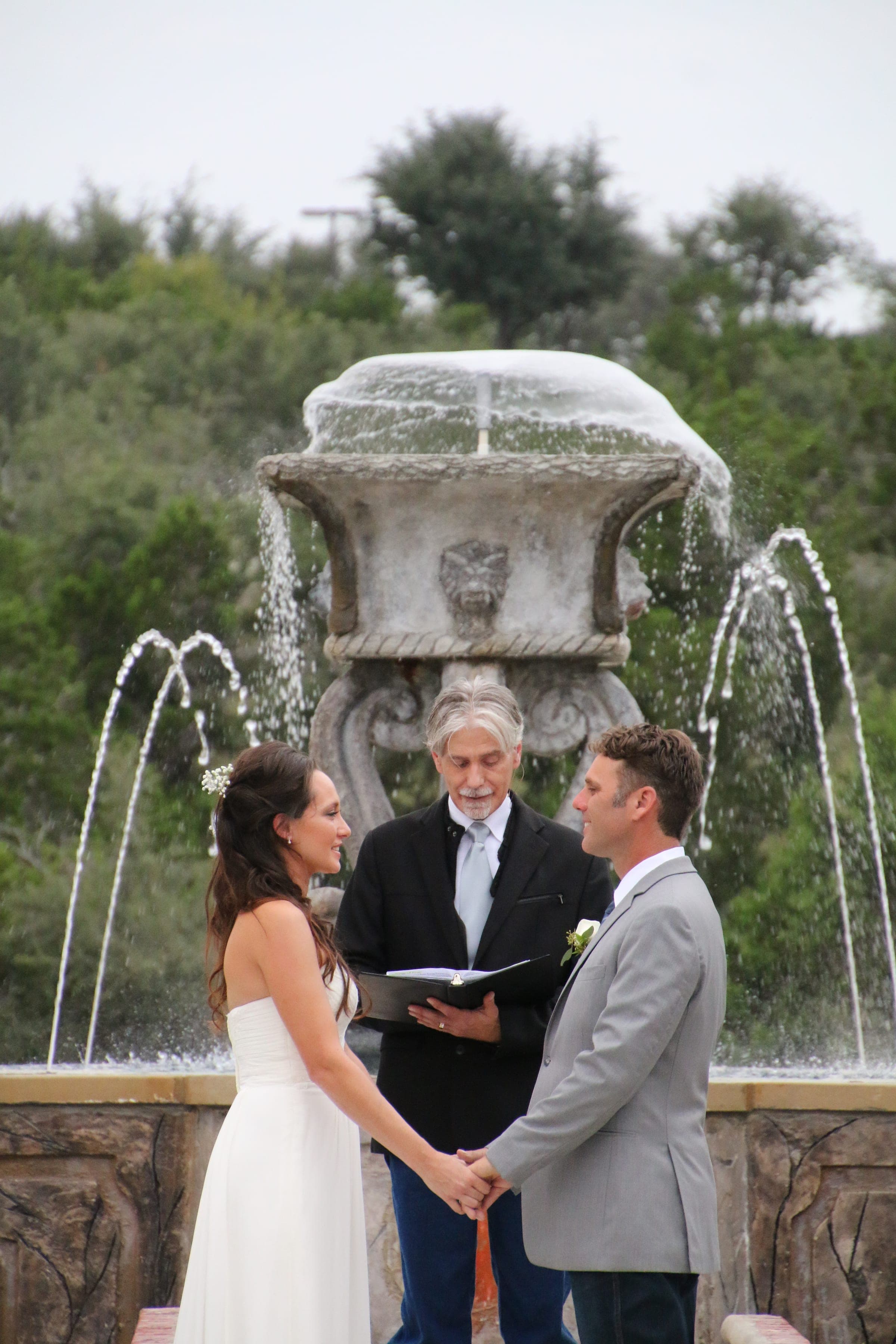 Newlyweds sharing a kiss at the fountain